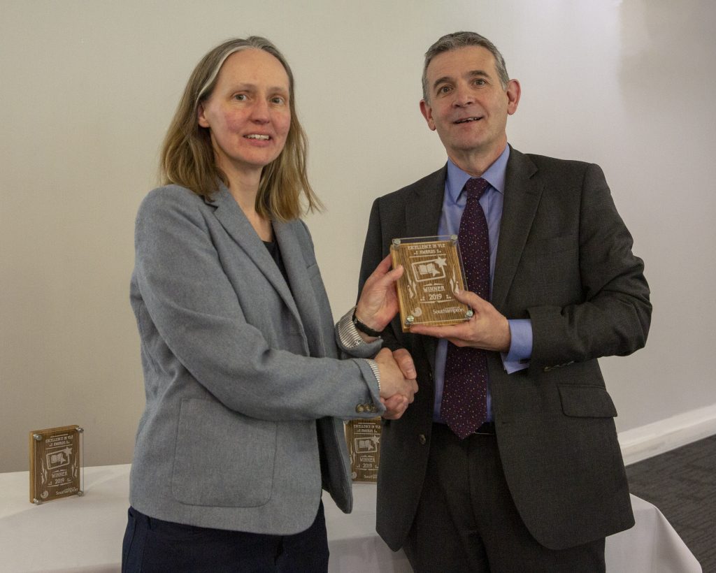 Dr Lisa Bernasak receives the award from Prof Alex Neill