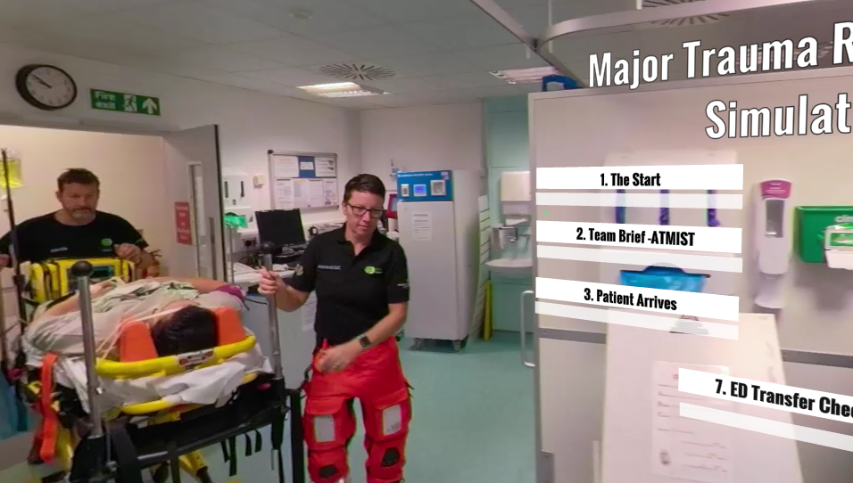 A screen shot of a video showing paramedics pushing a hospital trolley