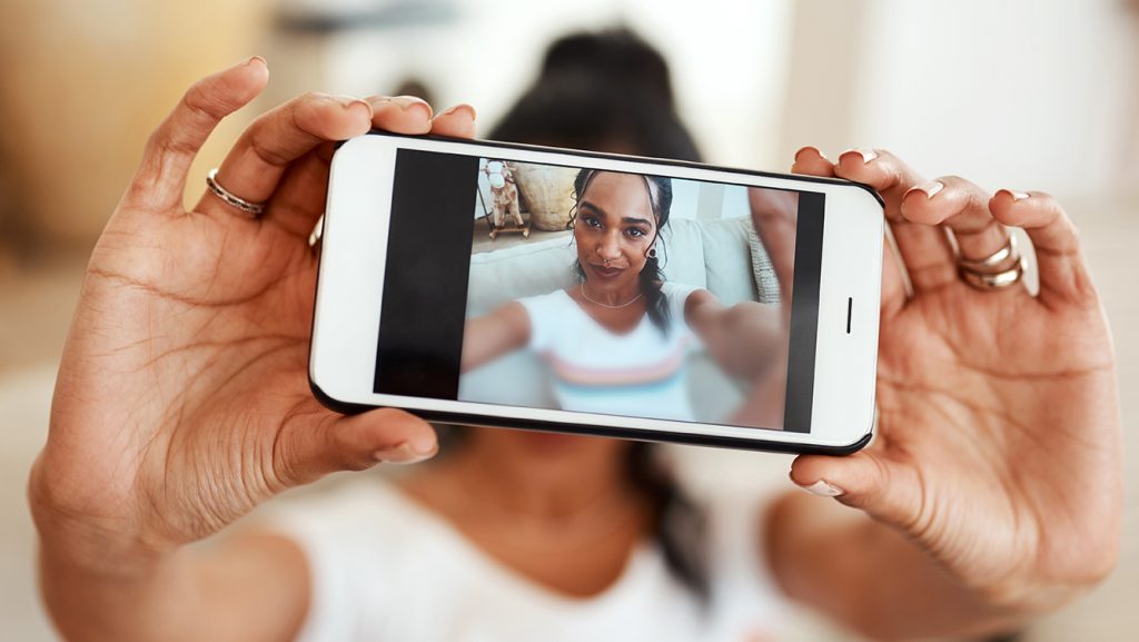Woman using phone in landscape mode
