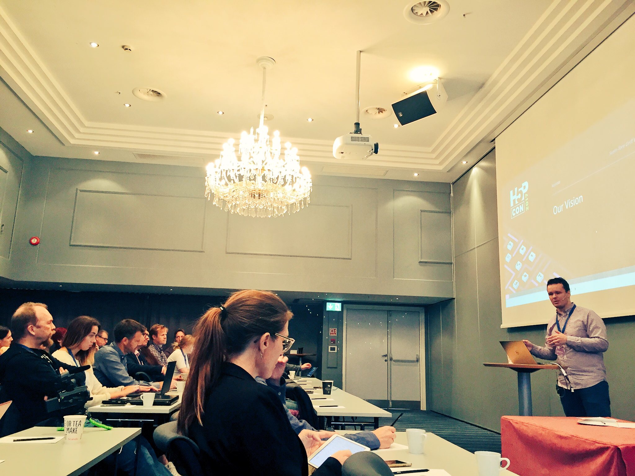 Image of spacious, packed conference room at H5P