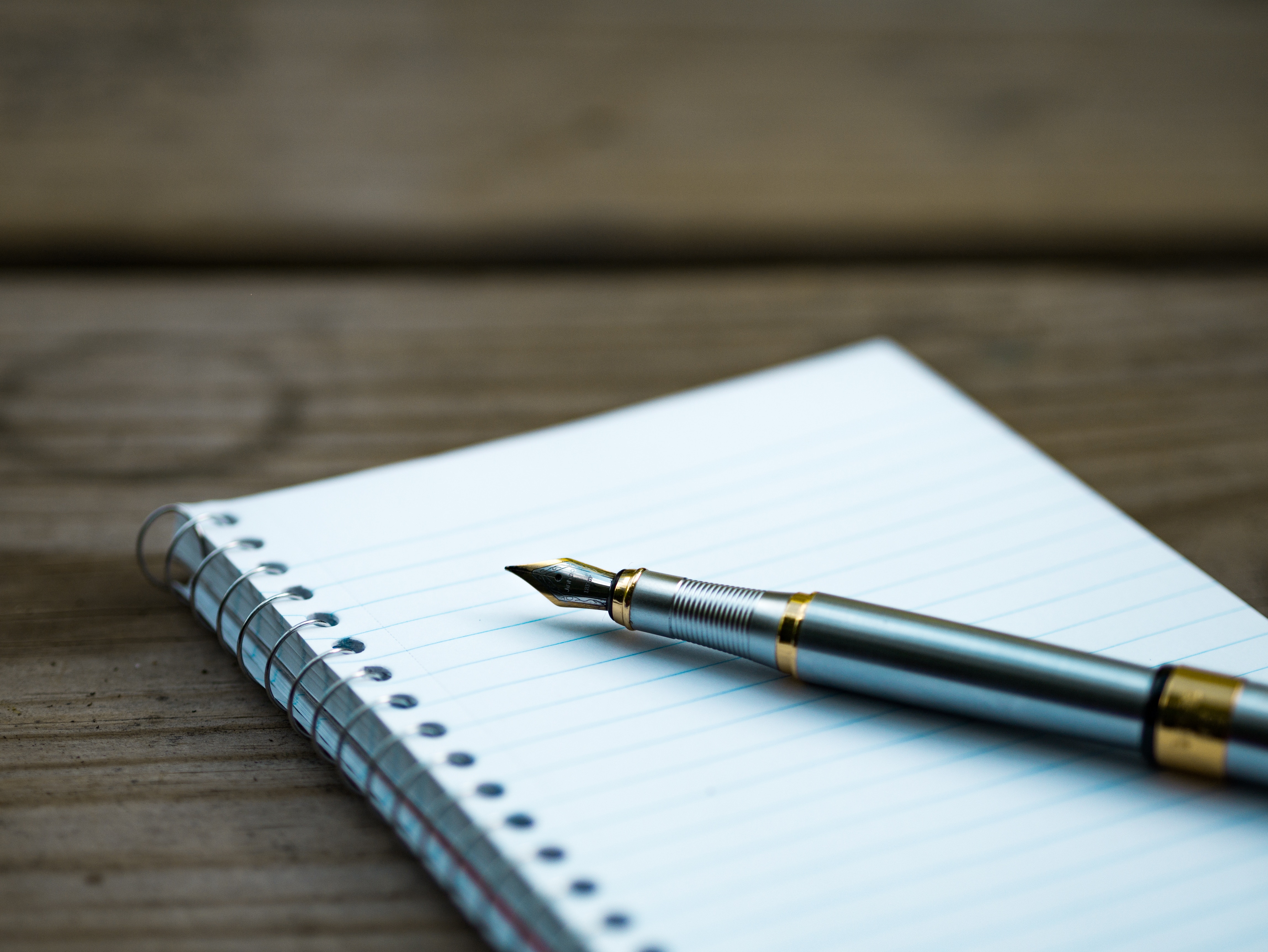 Close up of a pen and a notebook