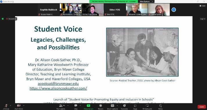 A screenshot of an online Zoom meeting, with a presentation slide on the screen which reads the title of the presentation and bears an image of 3 men and 2 women animatedly looking at a paper, captured by Alison Cook-Sather from Radical Teacher (2002). 