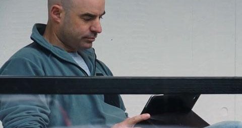 a person is pictured reading an iPad