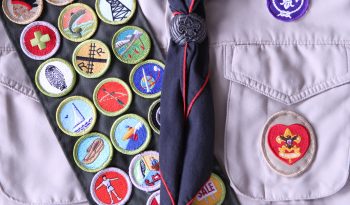 Sash with US Boy Scout badges on it.