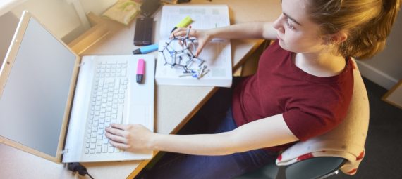 A female university student studies in her room.