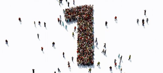 Human crowd forming a big number one on white background.