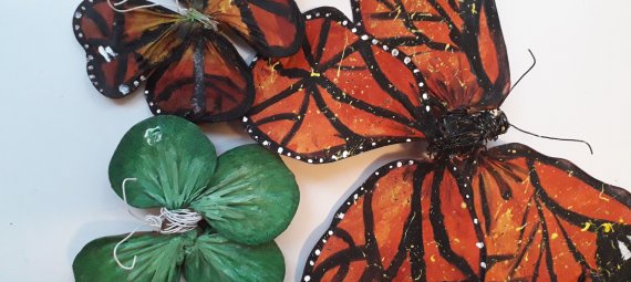Three model butterflies created by members of the public. One is green and the other two are traditional monarch butterfly colours and patterns.