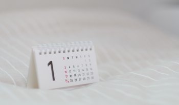 A desk calendar displayed on a white surface.