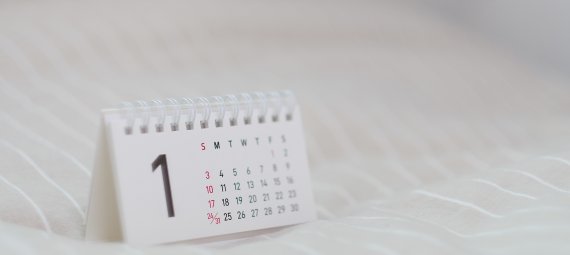 A desk calendar displayed on a white surface.