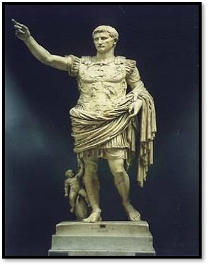 Statue of Augustus in a commanding pose with his right arm extended forward, he is also dressed in Roman military attire