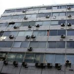 photo of haphazard installation of split aircon units in a tower block