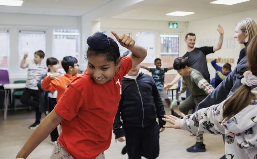Children dancing in creative curriculum lesson